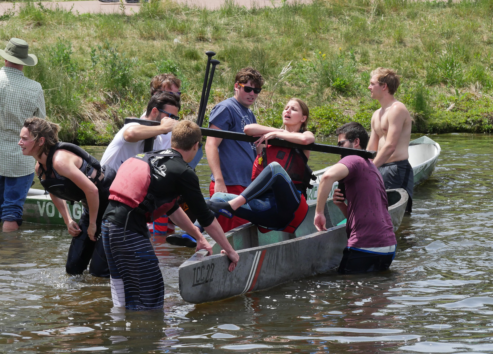 Concrete Canoe participant gets help exiting a boat.
