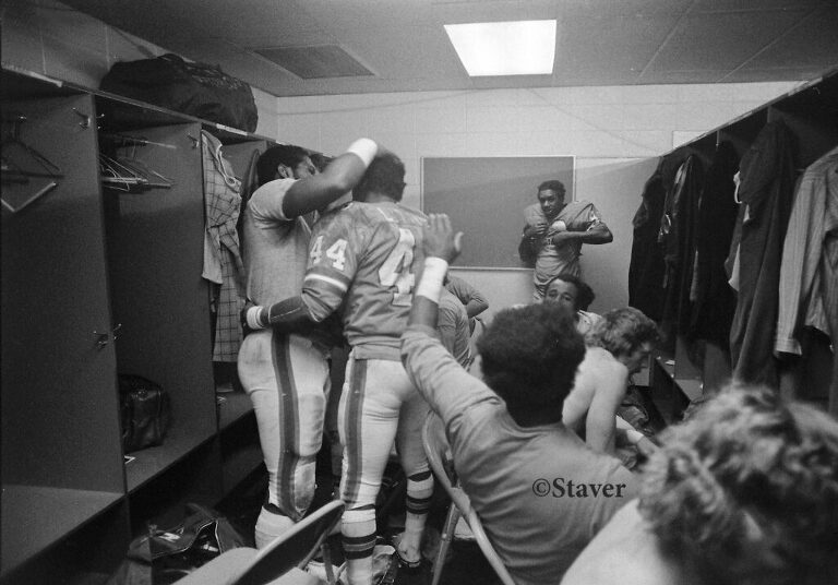 Bronco Floyd Little is congratulated by teammates in their locker room at Denver's Mile High Stadium.